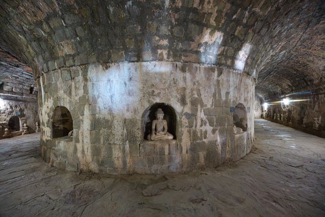 Tunnel with ancient ruins of Buddha statues in Kothaung Paya temple in Mrauk-U city, Rakhine state, Myanmar