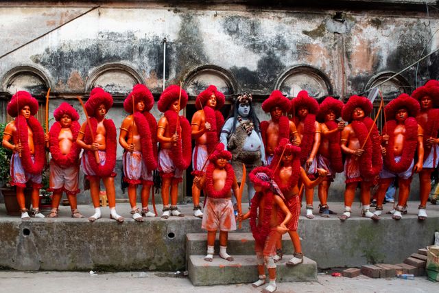 Young participants in vibrant red and orange attire during an Indian festival celebration