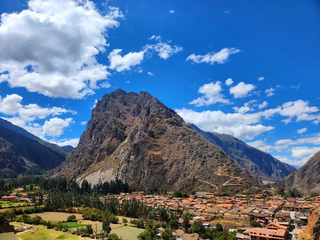 Beautiful view of Ollantaytambo village and Andes mountains under a blue sky