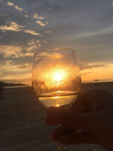 Glass of white wine against the sunset