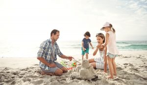 Family at the beach - Travelling with small kids