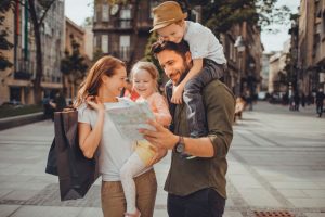 Family looking at a map - Travelling with small kids