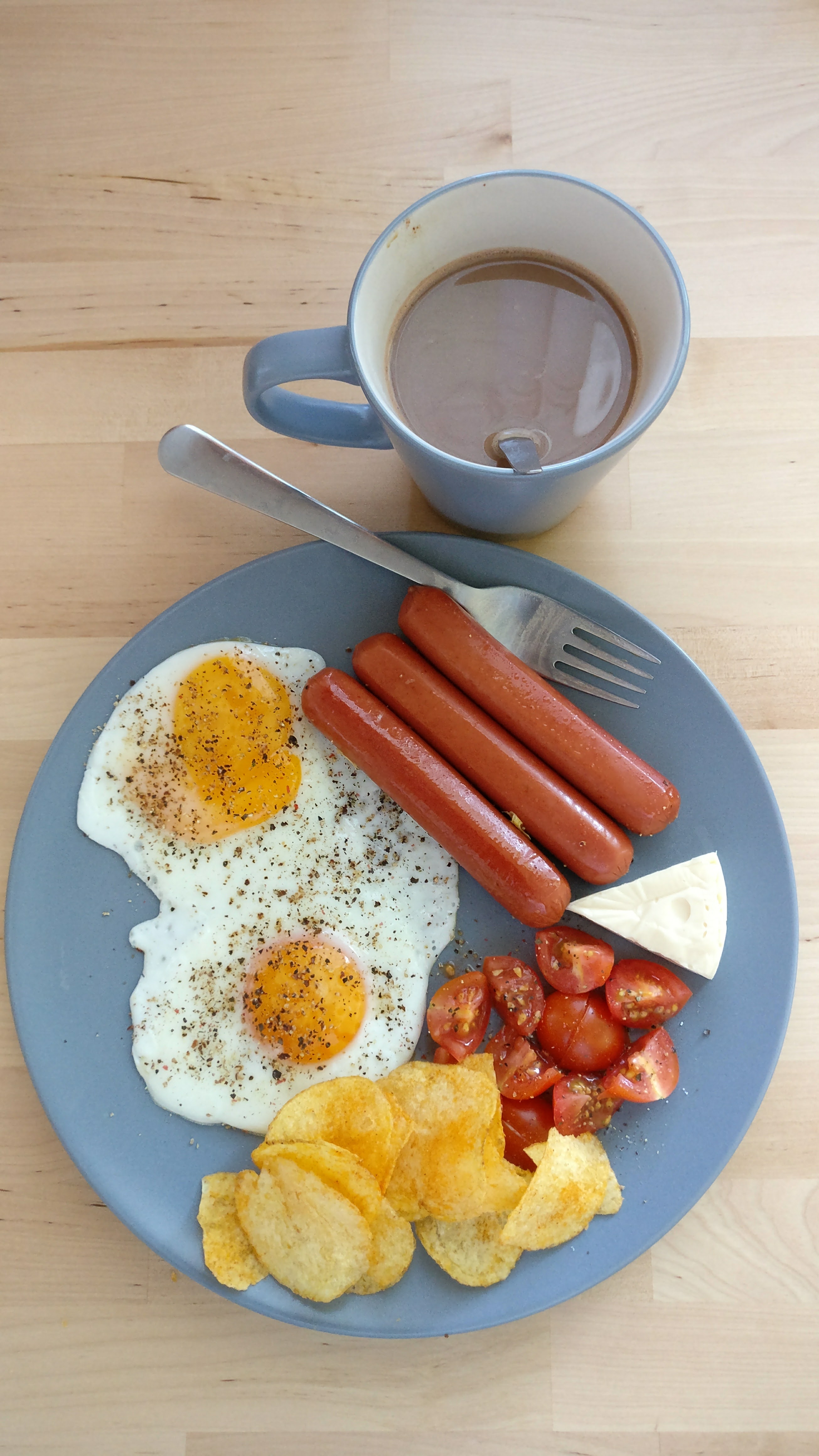 a breakfast plate with hot chocolate 