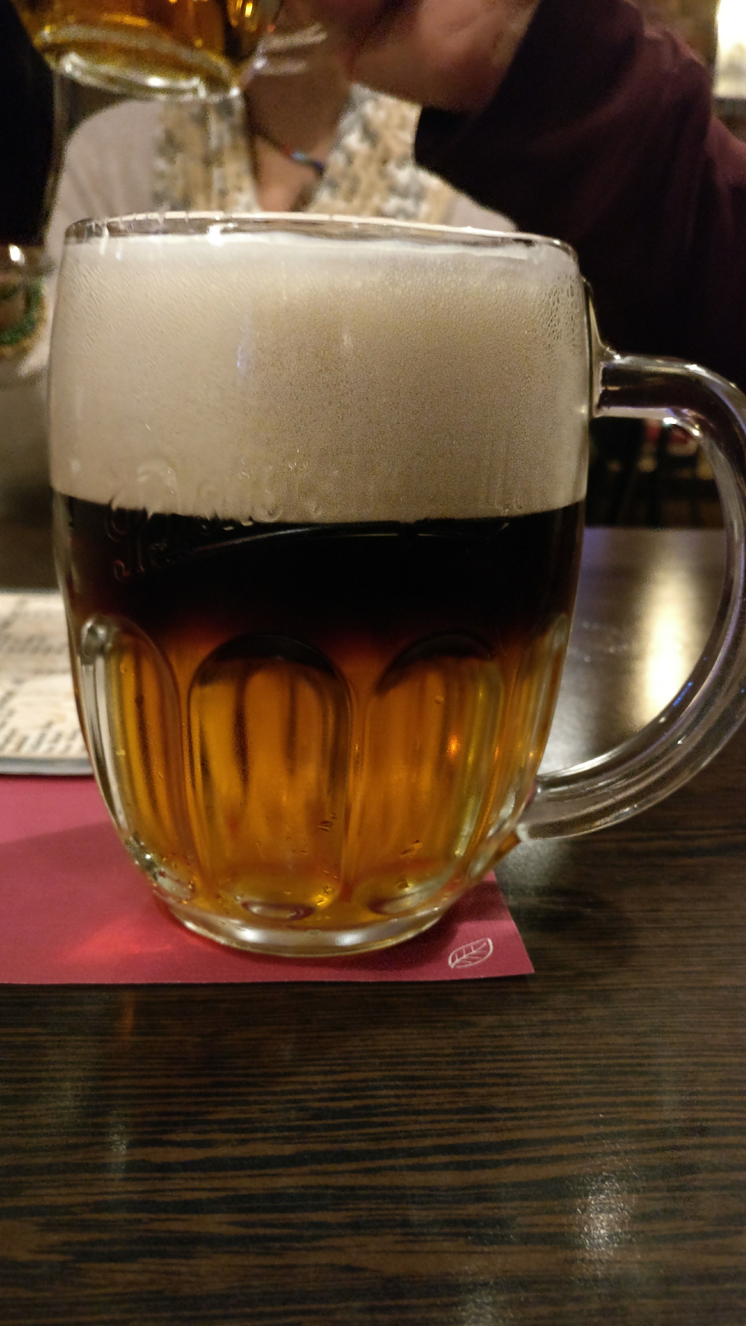 A mug of dark and light beer in Prague