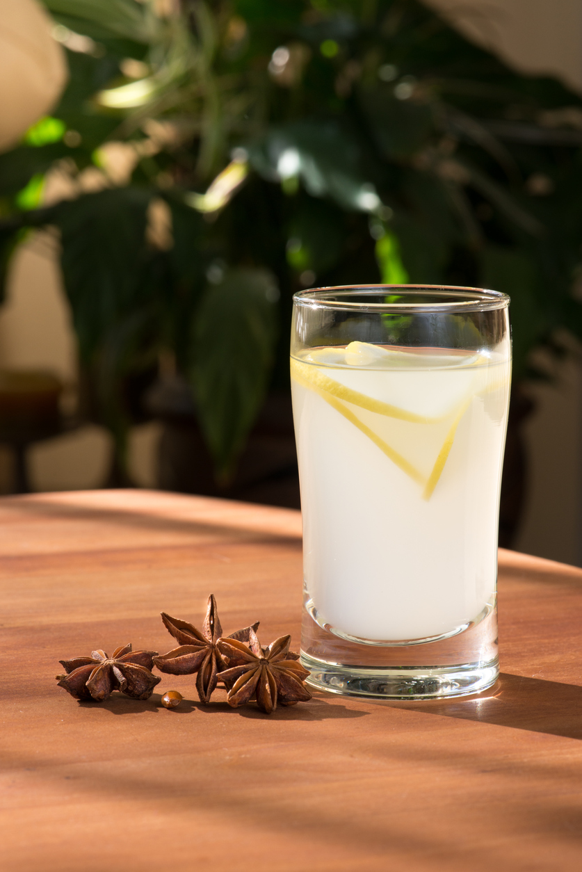 Shot glass of Greek Ouzo mixed with lemonade