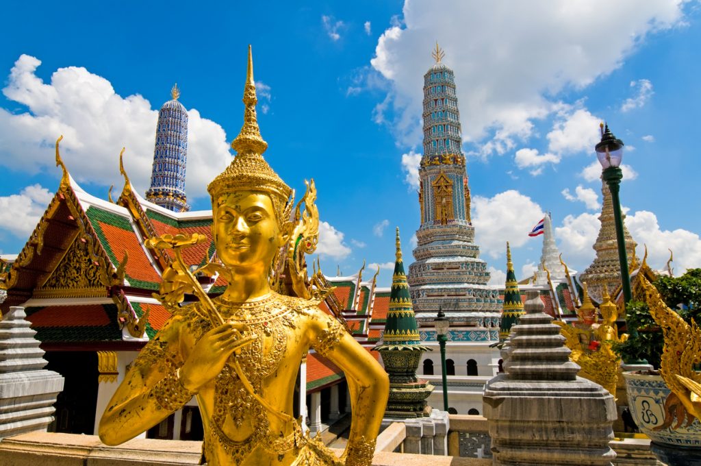 Wide angled view of Buddha sculpture Kinora or Kinnaree ( mythological creature, half bird, half man ) at Wat Phra Kaeo and Grand Palace in Bangkok, Thailand. Bangkok on a budget