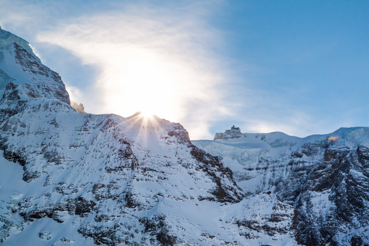 Sun shining over a peak in Jungfraujoch