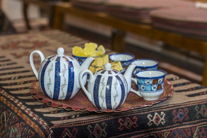 Typical teapots and cups in a traditional tea house in Iran