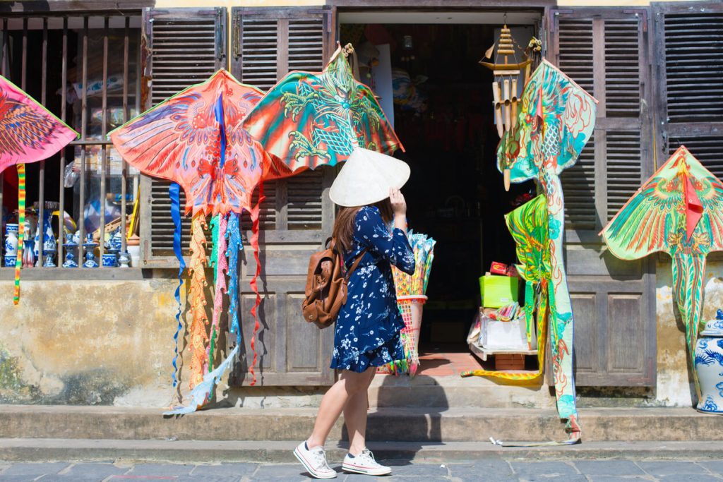 A tourist wearing a traditional Vietnamese hat, Vietnam budget travel