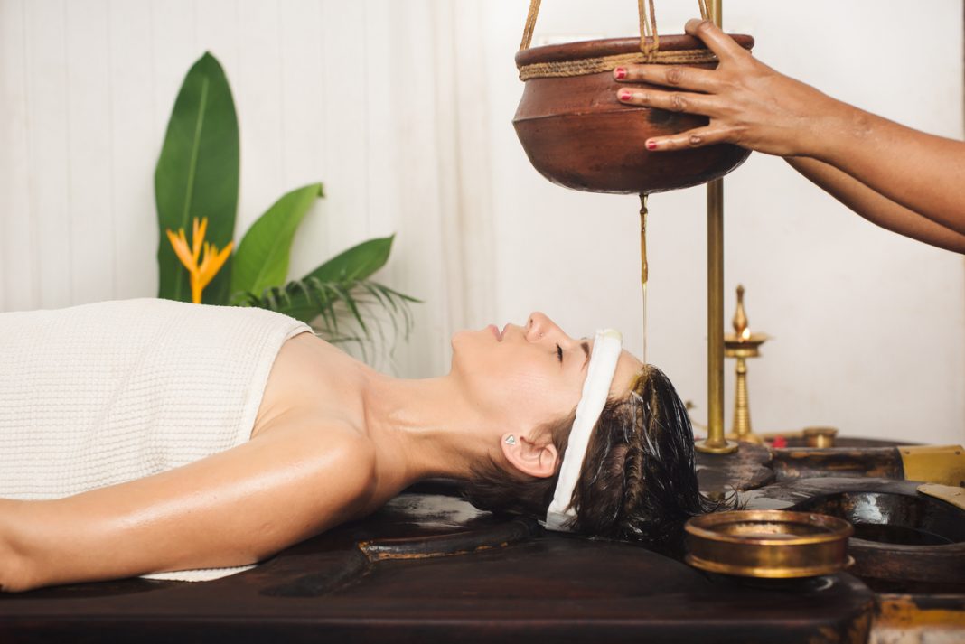 Kerala Ayurvedic massages, Tourist having Ayurveda shirodhara treatment in India