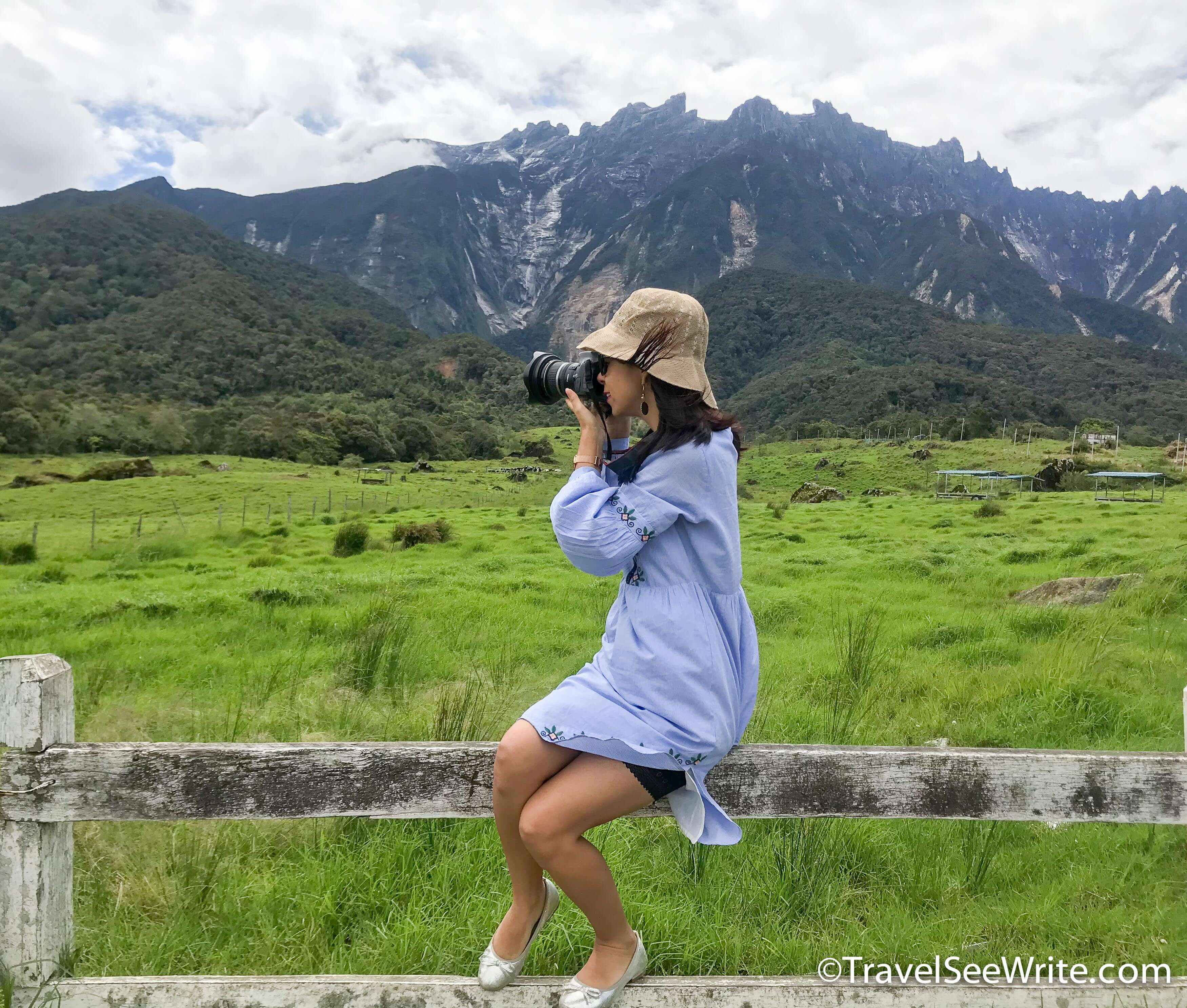 Lady clicking a photot of Mount Kinabalu in the background - southeast asia travel