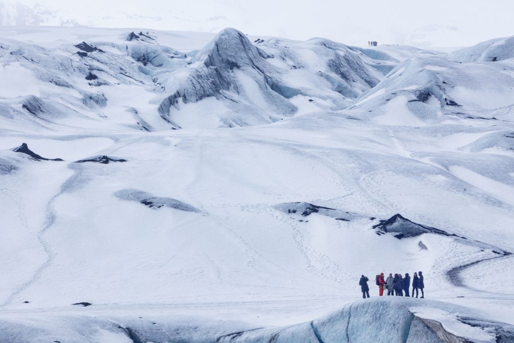 People preparing to go on a glacier hike at Mýrdalsjökull glacier in Iceland- peaceful places 