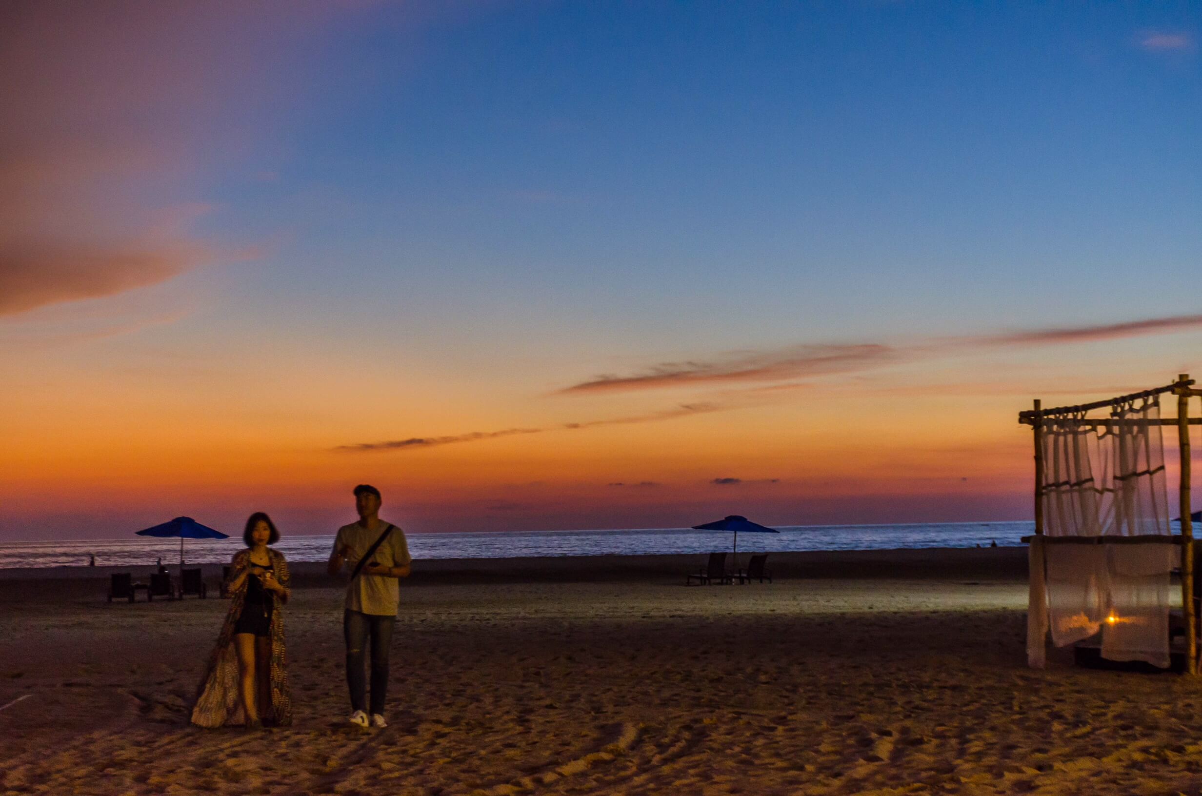 A couple at Pantai Dalit beach during sunset - Sabah beaches and islands