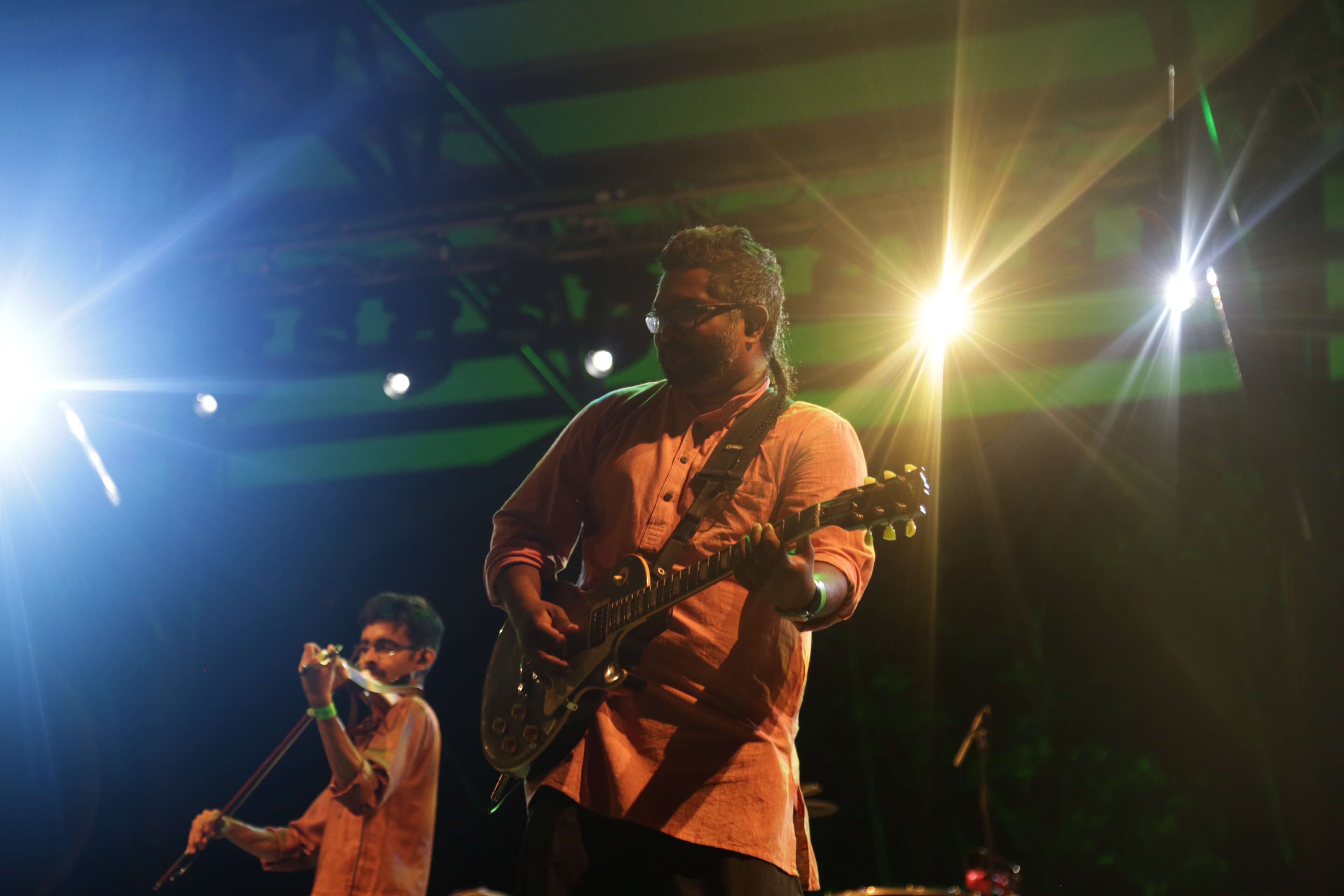 The guitarist and violinist of Raghu Dixit Project performing at the Rainforest World Music Festival (RWMF) 2018