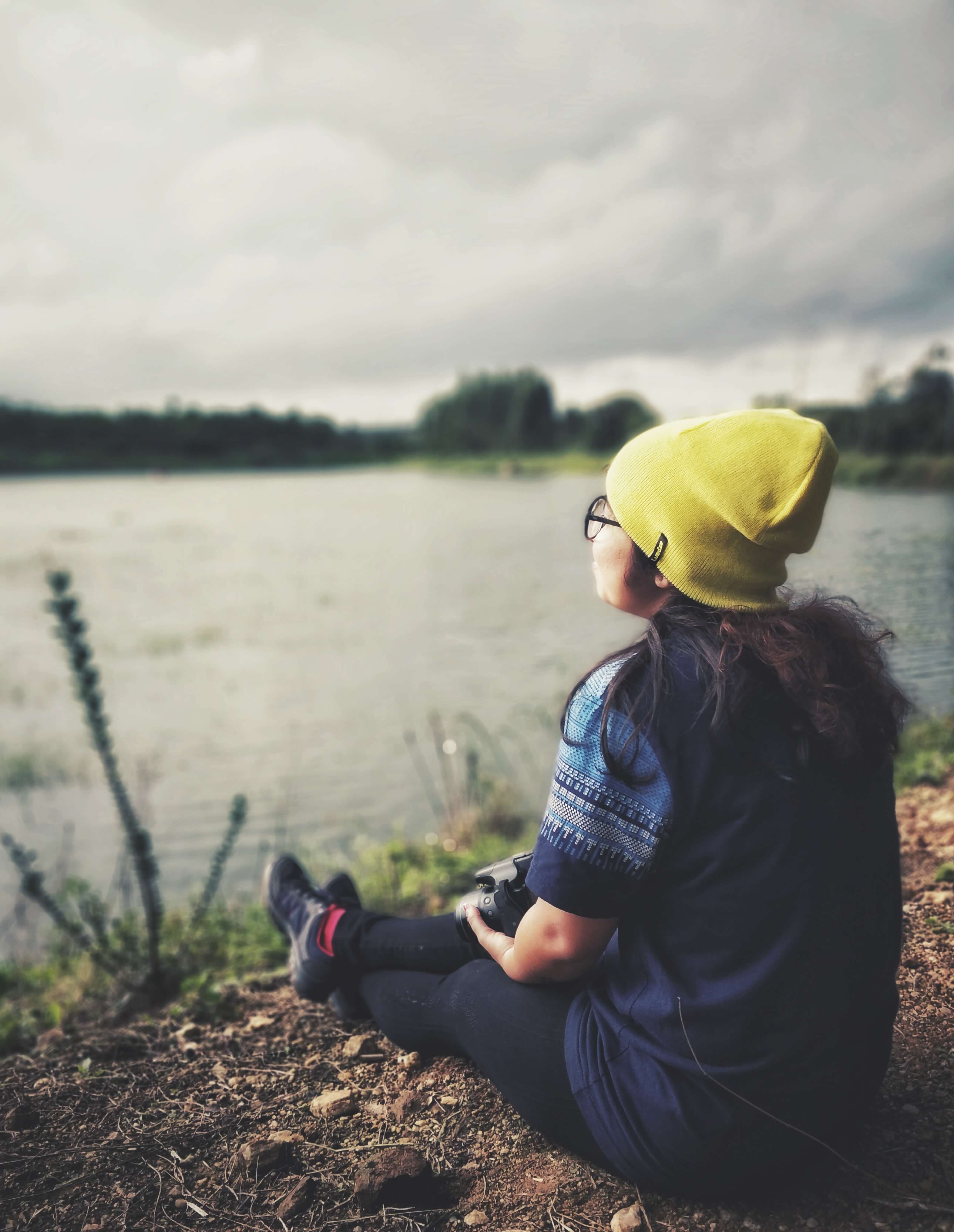 Person sitting by the lake - Malanad Calling