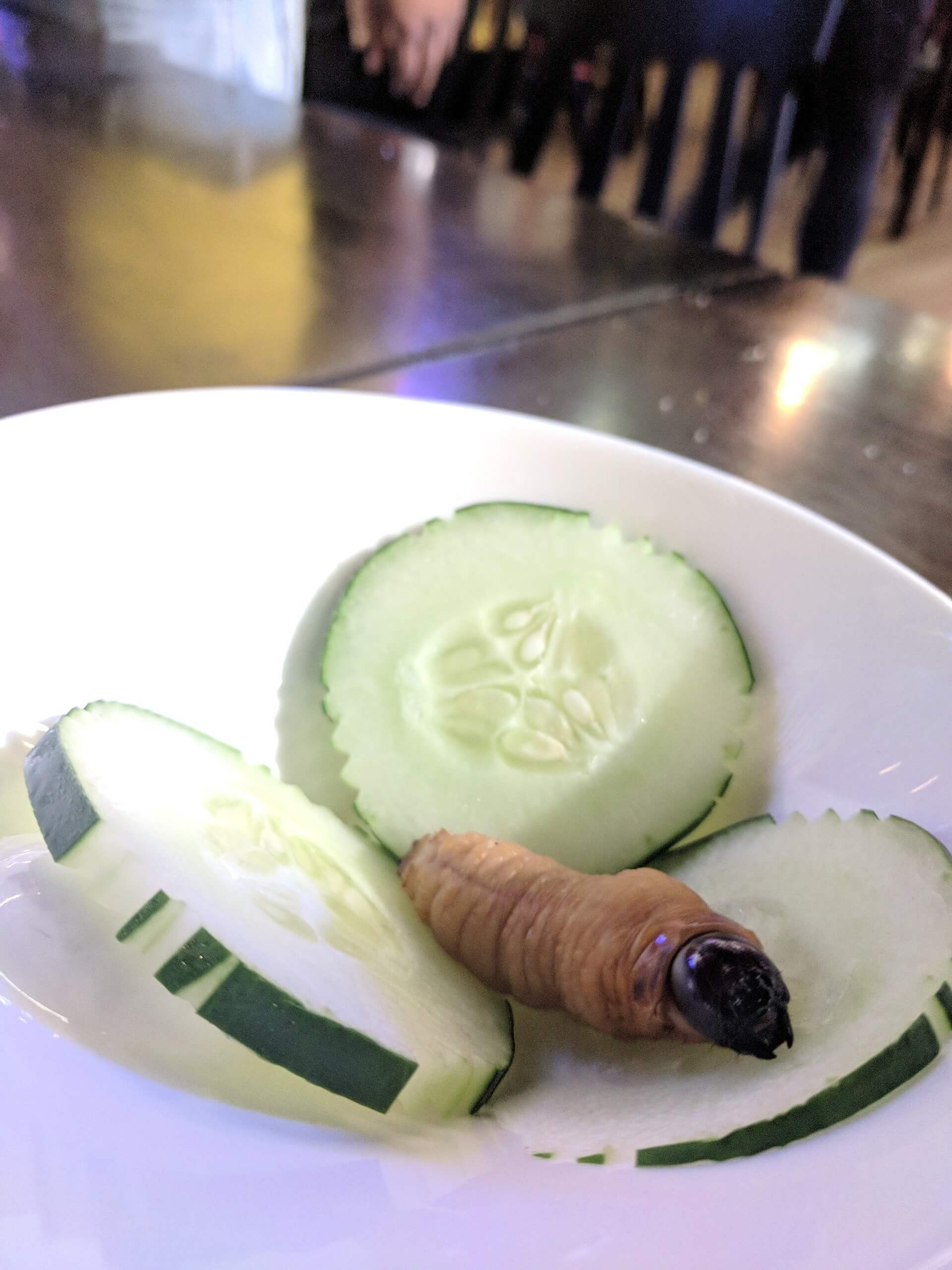 A sago worm on cucumber slices - Sabah market