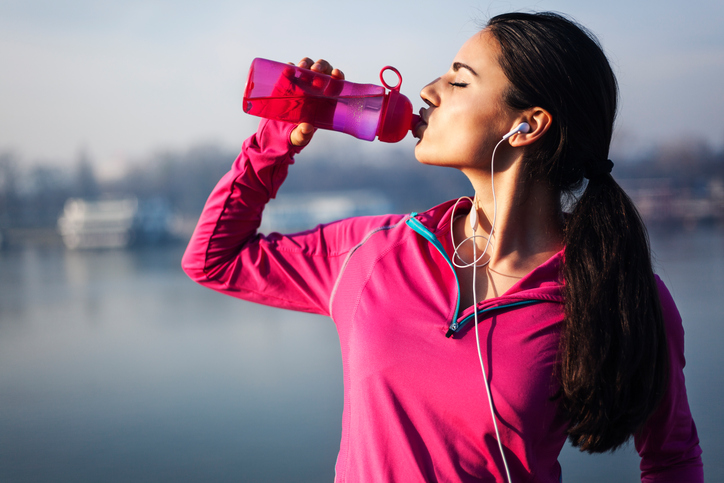 Woman drinking water, it removes toxic from body and makes skin brighter