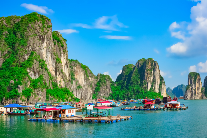 Floating fishing village and rock islands in Halong Bay, Vietnam, Southeast Asia. UNESCO World Heritage Site.