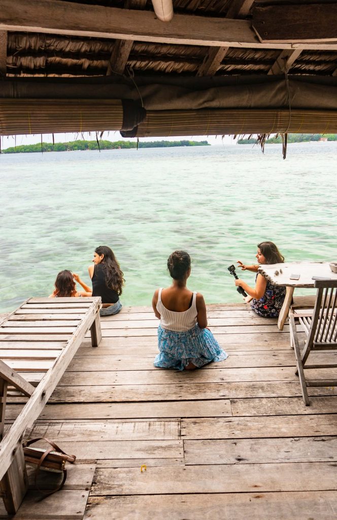 People sitting on the deck of Pulau Macan Island (Tiger Island)