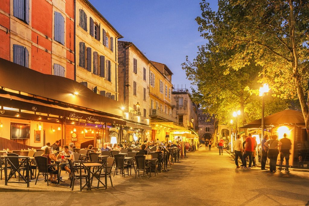 Arles, France - September 4, 2017: Locals and tourists spending time at the Place du Forum with its Cafés and Bistros.