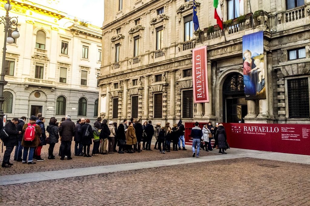 Milan, Italy - December 25, 2014: People waiting in line to enter temporary Raffaello Exhibit, Milan