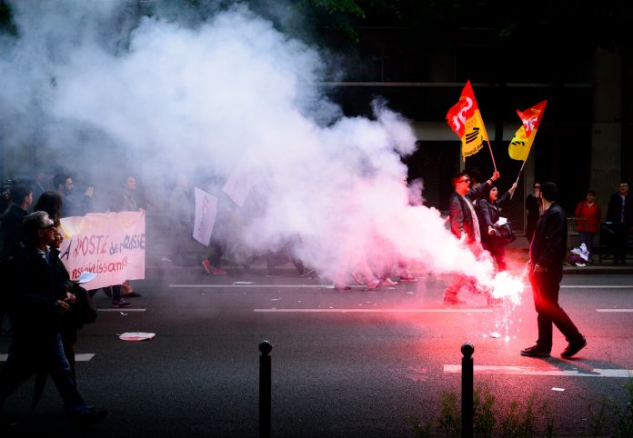 Paris, France - May 12, 2016 - French unions and students protest in Paris, France after the government forced through controversial labour reforms. | Source: Unsplash Paris, France - May 12, 2016 - French unions and students protest in Paris, France after the government forced through controversial labour reforms. | Source: Unsplash