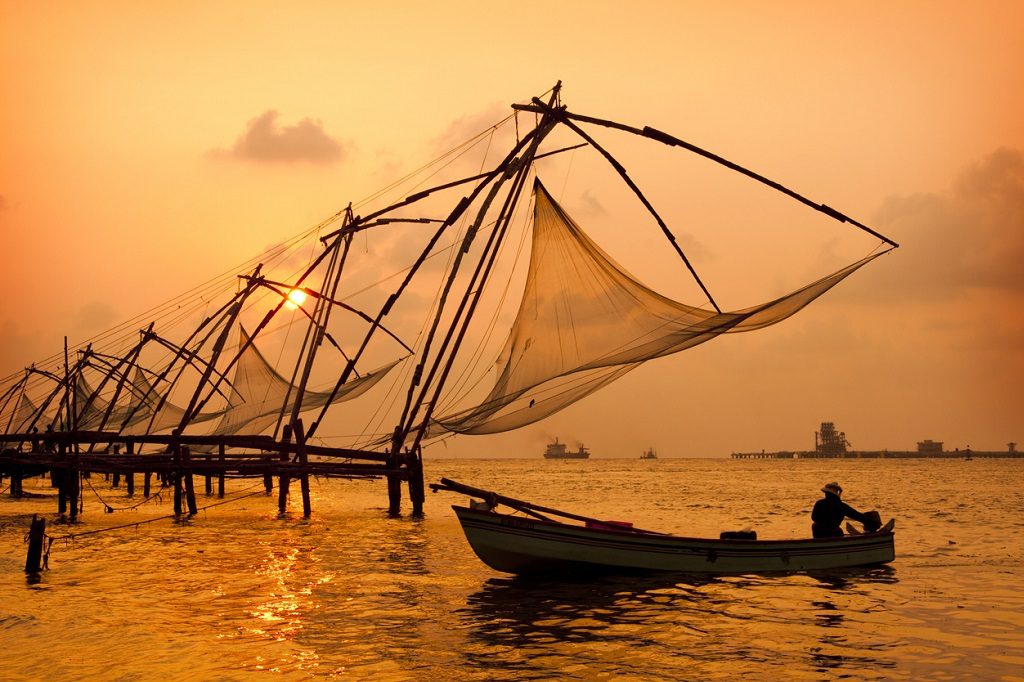 Sunset over Chinese Fishing nets and boat in Cochin (Kochi), Kerala, India.Sunset over Chinese Fishing nets and boat in Cochin (Kochi), Kerala, India.