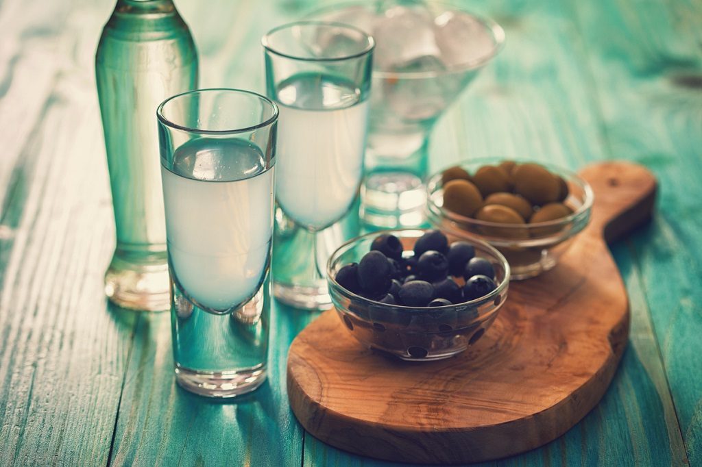 Favorite Greek summer drink Ouzo,flavor liquor made with the anise plant , served with Calamata Olives.