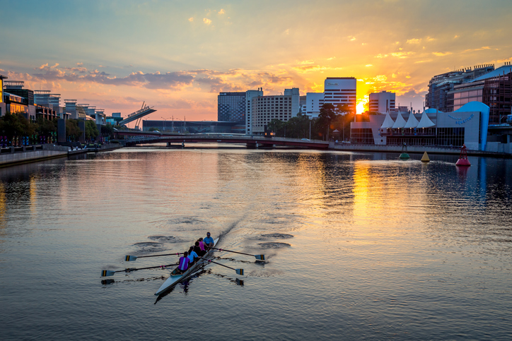 People kayaking at sunset on the Yarra river in Melbourne city center, Australia