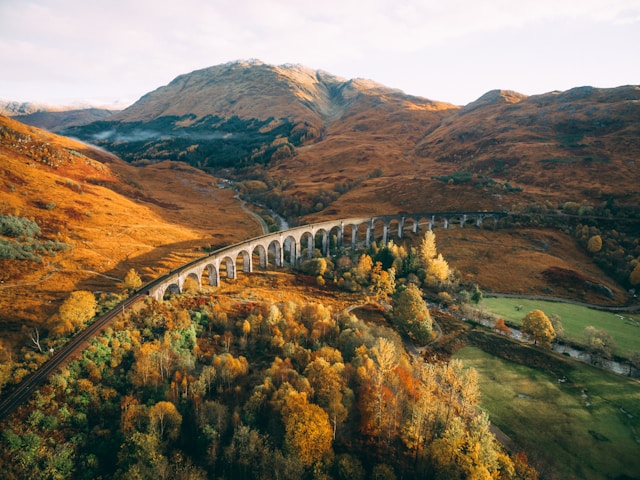 The Jacobite steam train crosses the Glenfinnan Viaduct in the Scottish Highlands