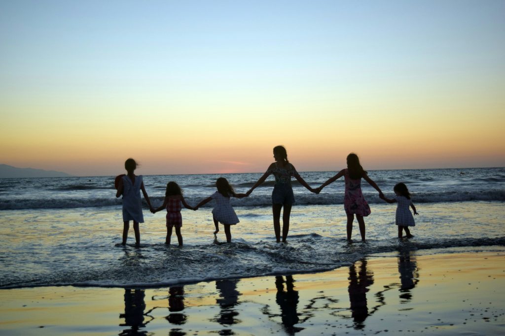 Family with kids walking on the beach in Bali
