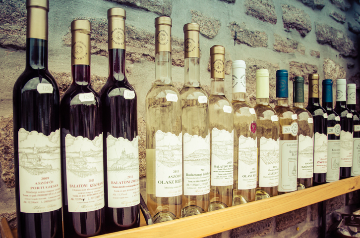 Bottles of Hungarian Wine on a shelf outside a shop in Tihany, Hungary.