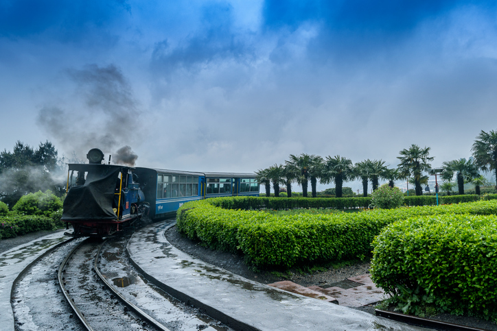 The Darjeeling Himalayan Railway, also known as the Toy Train, is a 2 ft narrow gauge railway,is entering to the Batasia loop,Darjeeling, west bengal, India. after a heavy rainfall.