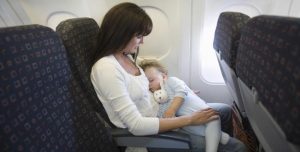 Mother breastfeeding baby in flight