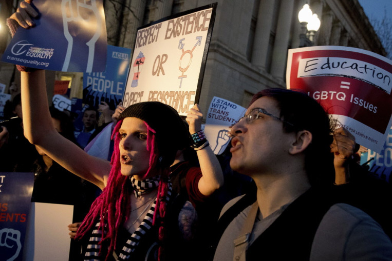 Activists and protesters with the National Center for Transgender Equality rally in front of the White House, Wednesday, Feb. 22.
