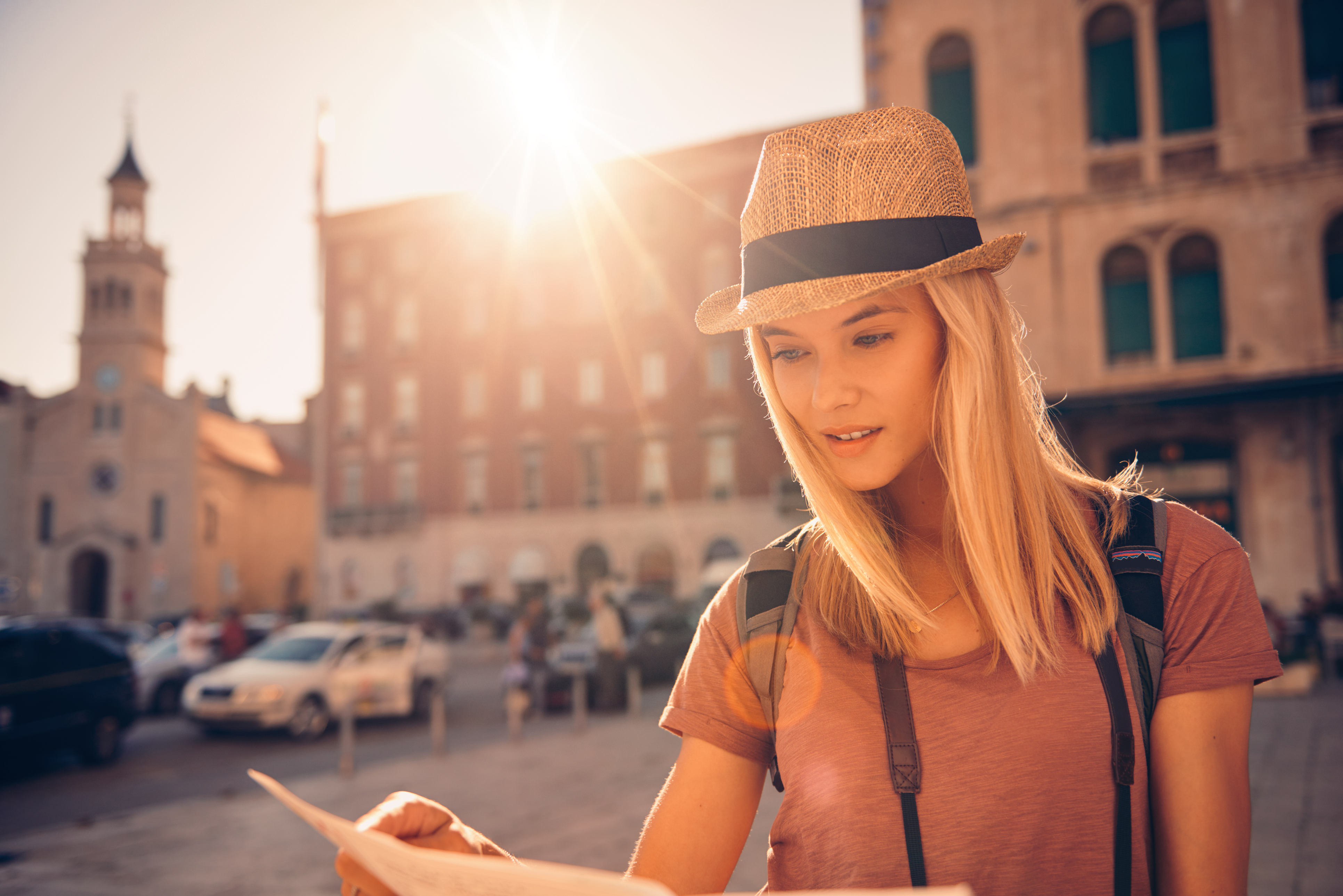 Shot of a young woman looking at a map while touring a foreign city