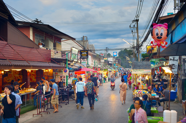 PAI, THAILAND - JAN 03, 2017: People walking on Pai night market at twilight. Pai is the famous tourist attraction in Thailand