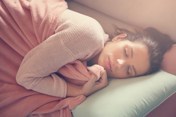 Serene Caucasian woman napping on the couch.