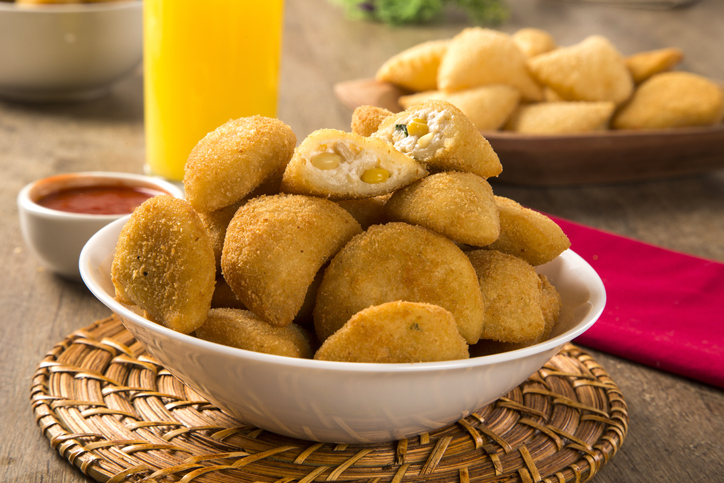 Rissole - Corn and cheese rissole served with chili sauce on wooden background.