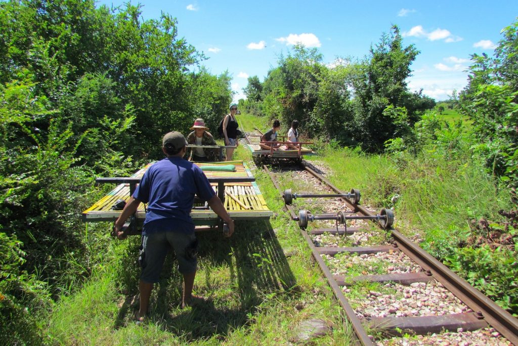 tourists doing Bamboo train in Cambodia