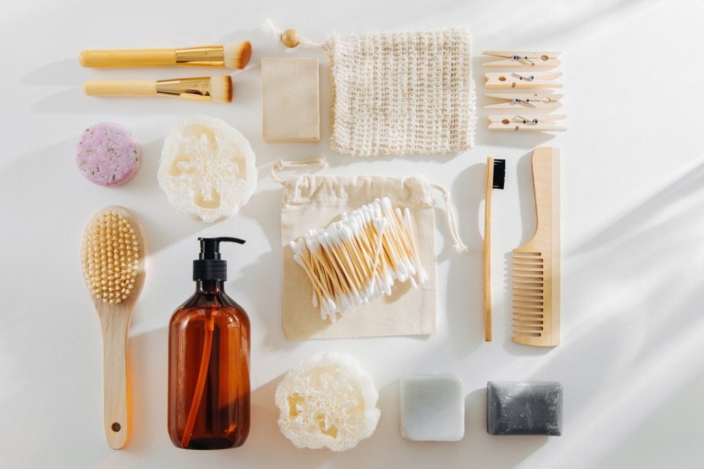 Set of Eco cosmetics products and tools. Soap, Shampoo Bottles, bamboo toothbrush, natural wooden brush. Zero waste, Plastic free. Sustainable lifestyle concept.