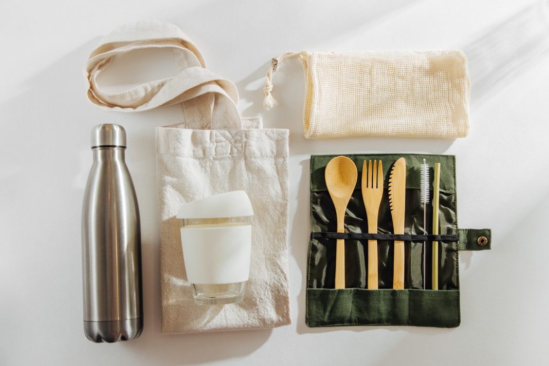 Set of Eco friendly bamboo cutlery, eco bag reusable coffee mug and water bottle. Sustainable lifestyle. zero waste travel