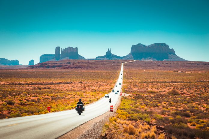 Biker on Monument Valley road at sunset, USA