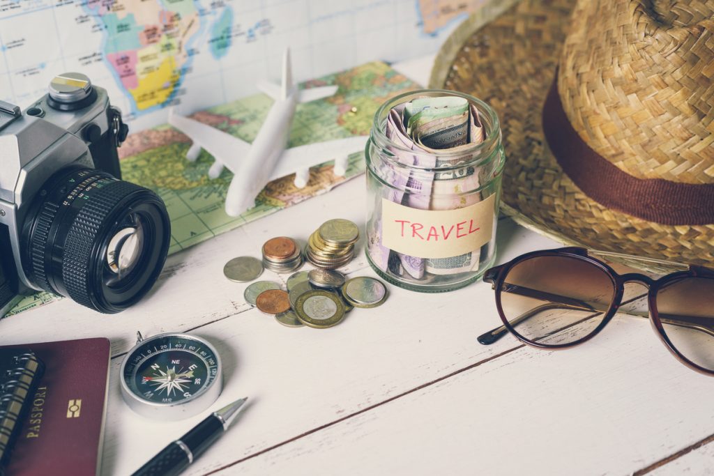 Collecting money for travel with accessories of traveler, Travel concept, budget travel tips