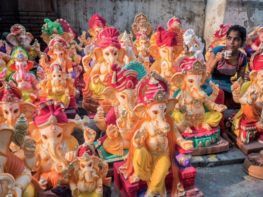 Woman selling ganesha statues for Ganesh Chaturthi India