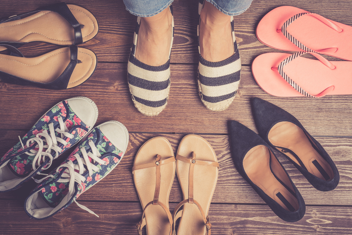 Collection of female shoes on wooden floor. Fashion background