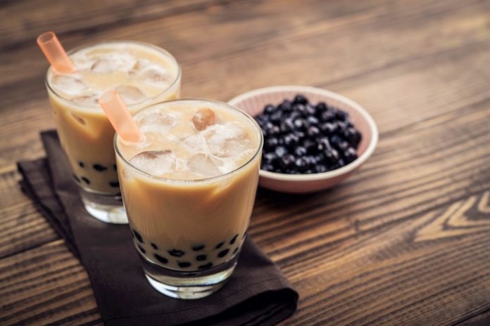 Homemade Milk Bubble Tea with Tapioca Pearls on wooden background