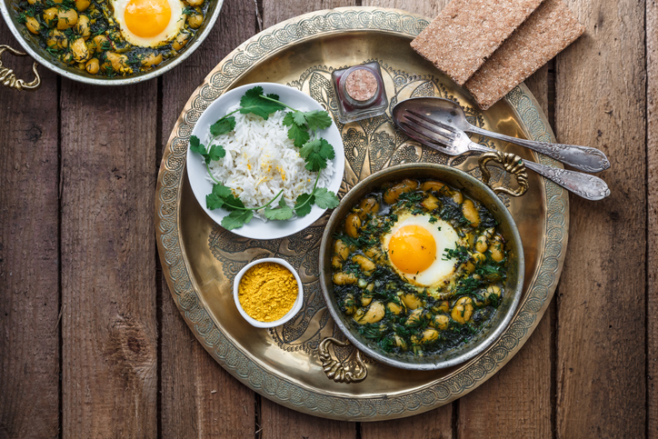 Eggs with bean, dill and rice bahali gatoush served in copper dishware, top view