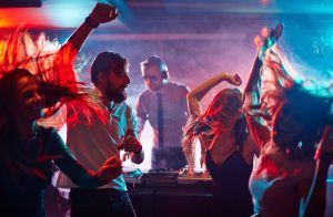 Group of dancing friends enjoying night party