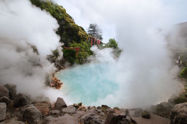 Geothermal hot spring with steam and rocky surroundings